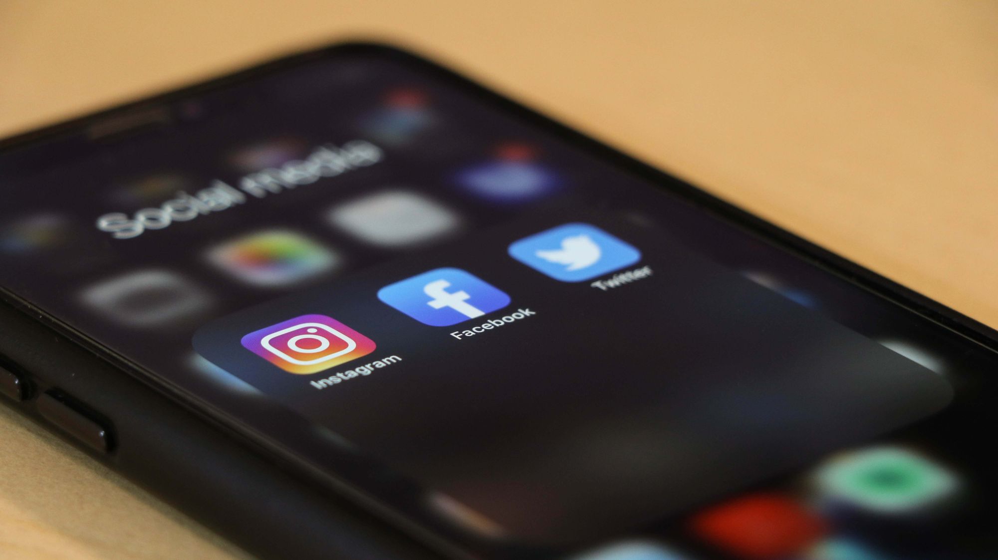 Image of a smartphone with the Instagram, Facebook and Twitter app.